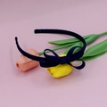 Navy blue ribbed bow headband placed on tulip props over a sweet pink background - Navy Blue