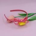 Close-up of pink ribbed fabric headband with a double-layered sweet bow design - Watermelon red
