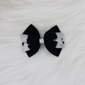 Détail du nœud papillon en ruban gros-grain noir avec sequins argentés sur fourrure - Noir