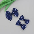 Detailed macro view of three navy blue grosgrain ribbon hair bows with white stars - No.02