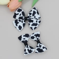 Détail d'un lot de barrettes à nœuds motif vache sur ruban gros-grain de qualité - Style Imprimé Vache (01#)