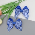 Detail showing a pair of blue plaid bow hair clips made of high-quality grosgrain ribbon - Royal Blue
