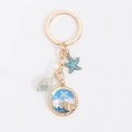 Llavero de concha marina dorada con estrella de mar y colgante de resina azul océano - Azul