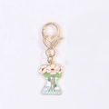 Floral flask keychain with pink daisies in a gold finish and heart lobster clasp - Morning Glory