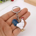 Colorful rooster keychain in metal with white, blue, and red enamel finish details - White Rooster