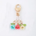 Charming lily of the valley keychain with colorful resin flowers and golden heart clasp - Blue Red Yellow Lily Of The Valley
