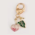 Pink peach fruit keychain pendant with golden lobster clasp and green enamel leaf - Peach