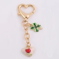 Portachiavi a cuore dorato con trifoglio verde e ciondolo con motivo a rosa bianca - Cuore Rosa