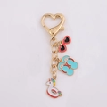 Golden heart keychain featuring unicorn floaty, red sunglasses, and blue flip-flops charms - Swim Ring Slipper Heart Sunglasses