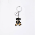 Cute Rottweiler enamel keychain with a paw print charm on a stainless steel ring - Lying Rottweiler (Paw)