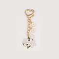 Floral metal keychain with white lily and daisy pendants on a gold heart-shaped clasp - Lily String