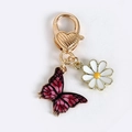 Porte-clés papillon rose violet avec breloque marguerite et fermoir cœur doré - Papillon noir rouge