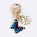 Blue and pink gradient butterfly keychain with white daisy charm and gold heart clasp - Blue and Red Butterfly