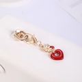 Golden ladybug keychain with white daisy and red heart charm on minimalist background - Heart with Hole