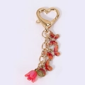 Porte-clés papillon coloré et tulipe rose avec fermoir en forme de cœur doré - Antennes de coccinelle rouge