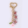 Porte-clés papillon doré et fleur avec fermoir en cœur et charmes en émail rouge - Papillon Rose