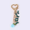 Porte-clés cœur doré orné de papillons en émail vert et de breloques fleurs bleues - Papillon Bleu