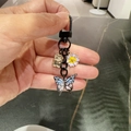 Black lobster clasp keychain with blue butterfly, white daisy flower and gold metal charm - Blue Butterfly