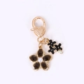 Portachiavi a cuore dorato con fiore marrone scuro e perla bianca centrale decorata - Fiore Singolo In Smalto Nero Trasparente