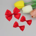 Detailed macro view of three vibrant red pleated satin ribbon bows for elegant hair accessories - Red