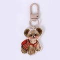 Cute acrylic puppy keychain with red striped outfit and khaki metal snap hook - Teddy in Red Clothing