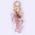 Llavero de flores de resina lila con acabado perlado y gancho dorado para bolso - Flor luminosa púrpura claro
