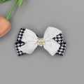 Detail of double-layer houndstooth and satin bow hair clip with pearl and rhinestone floral center - Navy Blue