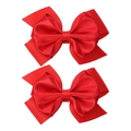 Close-up of two red ribbon hair clips featuring layered grosgrain and satin texture - Red