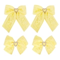 Detailed view of yellow lace hair clips with heart-shaped rhinestones and streamers - Yellow