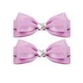 Detail of pink satin ribbon bow hair clips featuring a central white heart pearl embellishment - Purple