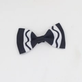 Detailed macro view of black and white wavy striped ribbon bow hair clip for girls - Black