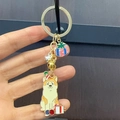 Christmas Shiba Inu keychain with Santa hat, golden bell, and gift box charm - Birthday Hat Akita