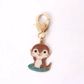 Cute cartoon otter enamel keychain with golden heart clasp and teal wave base charm - Otter Playing in Water
