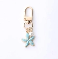 Golden keychain featuring a light blue starfish pendant and white pearl charm accessory - Blue Starfish And Artificial Pearl Style (海星蝴蝶)