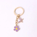 Golden keychain with a purple butterfly charm and a violet flower petal pendant - Purple Flower And Butterfly