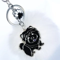 Détail d'un porte-clés pompon blanc avec pendentifs chien et patte en métal argenté - Chow-Chow Noir