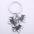 Detailed close-up of three miniature Schnauzer dog pendants with colorful enamel finish - Gray Set