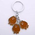 Detailed macro view of silver metal keychain with three brown pomeranian dog pendants - Brown Pomeranian / 10cm