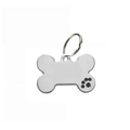 Close-up of bone-shaped silver metal pet ID tag with a black paw print detail - Black