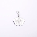 Macro detail of dog head shaped stainless steel pet tag with engraved facial features - Brittany Spaniel Style