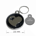 Macro detail of a 25mm stainless steel pet ID tag with a hollow heart and custom engraving - 25mm / Black