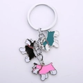 Close-up of Schnauzer pendants in black, pink and green enamel on a metal keychain - Mixed Color Strand