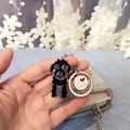 Close-up of black poodle keychain with I Love Dogs metal charm held in hand - Large Black Dog With Heart Tag