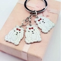 Dog shaped metal keychain with white enamel maltese pendants and red bows - Maltese Mix