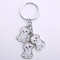 Silver metal keychain with three white enamel cartoon dog charms in a cute doggy style - White Bichon Frise Charm