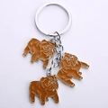 Detail of metal keychain featuring three brown enamel French Bulldog pendant charms - Sandblasted Bead Strand