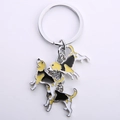 Detail of beagle dog enamel charms on a silver metal keychain with three puppy pendants - Foxhound Mix