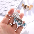 Detailed close-up of husky puppy enamel charms on a metal keychain with lock accessory - Blue Husky Charm