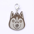 Detailed view of husky shaped stainless steel dog tag with silver lobster clasp and brown accent - Husky Style