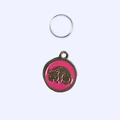 Close-up of a pink enamel round pet tag with a sleeping cat design and a metal ring - 2.5cm / Pink Cat